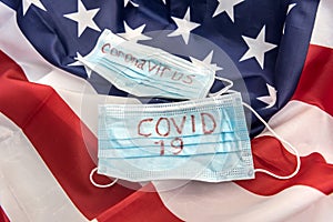 Covid 19 outbreak worldwide. protective mask with text coronavirus on flag of usa