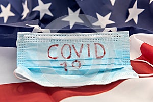 Covid 19 outbreak worldwide. protective mask with text coronavirus on flag of usa