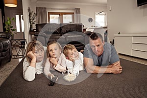 COVID-19 Outbrek. Bored family confined to their home watching tv during coronavirus lockdown