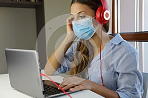 COVID-19 Pandemic Coronavirus Home Schooling E-learning Student Girl Mask Study from Home Laptop. Quarantine young woman studying
