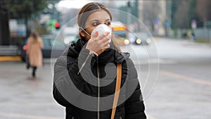 COVID-19 Pandemic Coronavirus Woman in city street wearing face mask protective for spreading of disease virus SARS-CoV-2. Girl wi