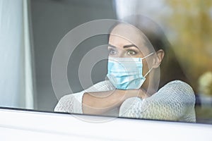 Covid-19 pandemic depression caused by social isolation during a quarantine by a face mask wearing female