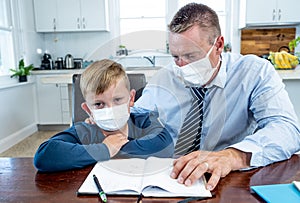 COVID-19 pandemic school lockdowns and self-isolation. Worried parent helping son studying at home