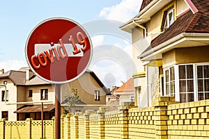 `Covid 19` and a road sign on the background of real estate .