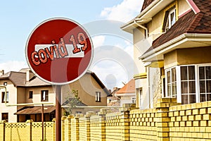 `Covid 19` and a road sign on the background of real estate .