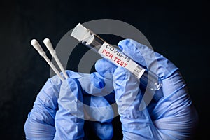 COVID-19 swab collection kit in doctor hands, nurse holds tube of coronavirus PCR test