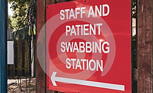 COVID-19 swabbing and testing station sign at a UK hospital