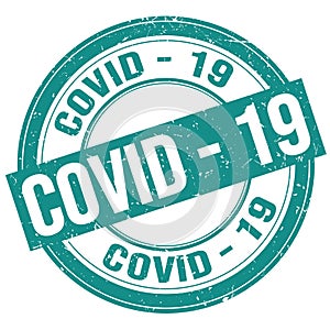 COVID - 19 text written on blue round stamp sign