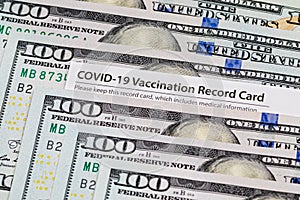Covid-19 vaccination card and cash money