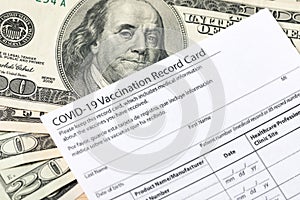 Covid-19 vaccination card and cash money - Image