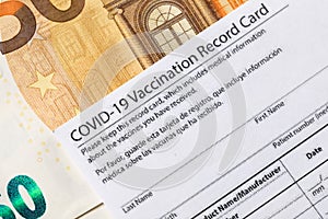 Covid-19 vaccination card and cash money - Image