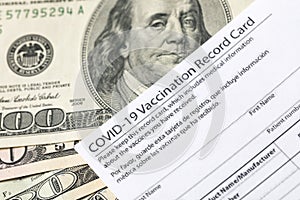 Covid-19 vaccination card and cash money - Image