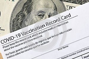 Covid-19 vaccination card and cash money - Image