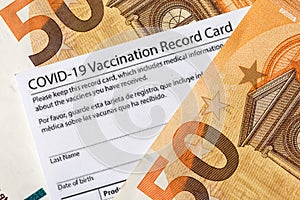 Covid-19 vaccination card and cash money - Image