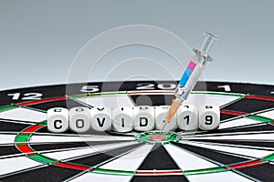 Covid-19 vaccination, syringe, dice, dartboard