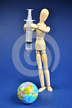 The covid-19 vaccine with a syringe. The concept of protecting the globe