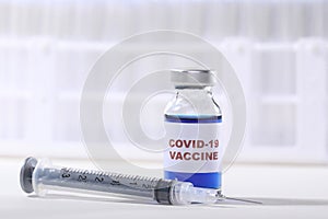Covid-19 Virus Vaccine Shot in Vial Ready to Administer on White