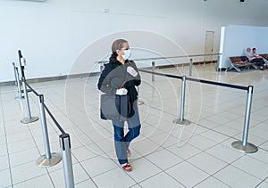 COVID-19. Woman stuck in a foreign country waiting at airport to be evacuated and return home