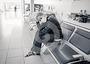 COVID-19. Woman stuck in a foreign country waiting at airport to be evacuated and return home