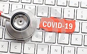 COVID-19 word on a small red card located on a computer keyboard. World Health Organization WHO introduced new official name for C