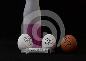 Covid-19 and coronavirus eggs drawn frightened faces alcohol syringe photo