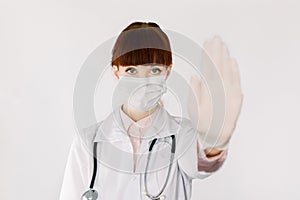 Covid19, coronavirus, healthcare and doctors concept. Serious Cauasian female doctor in medical mask, with stethoscope photo