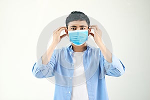 COVID-19 Coronavirus portrait handsome young asian man wearing mask protection from covid 19 isolated on white background in