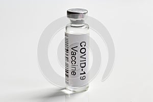 COVID-19 coronavirus vaccine on white background, bottle with vaccine for SARS-CoV-2 coronavirus cure photo