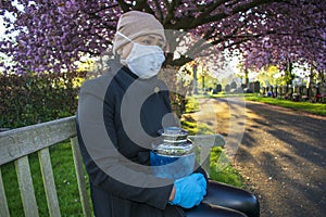 Covid-19 Mourner in Cemetery with Loved Ones Cremation Ashes in Funeral Urn photo