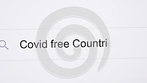 Covid free Countries list - pc screen internet browser search engine bar typing pandemic related question. Typing the