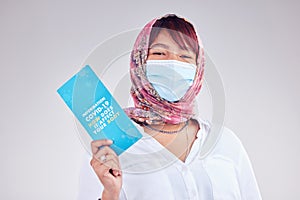 Covid, Muslim woman and mask for vaccine card, protection and healthy for wellness, happy and on grey studio background