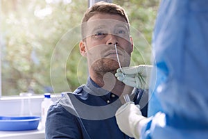 Covid-19 nasal swab test - doctor taking a mucus sample from patient nose photo