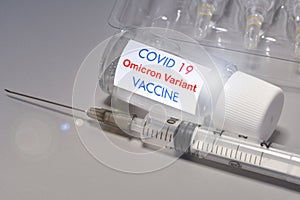 Covid-19 Omicron variant strain vaccine. Syringe and vaccine. Treatment for coronavirus covid-19 photo