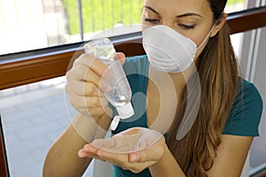 COVID-19 Pandemic Coronavirus Mask Woman Holding Hands Sanitizer Alcohol Gel Dispenser Against Novel Coronavirus 2019-nCoV.