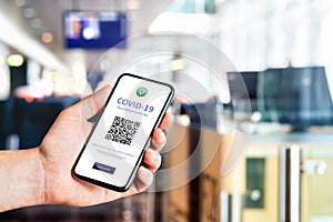 Covid pass certificate at airport. Digital corona virus vaccine document in phone. Electronic proof of coronavirus vaccination.