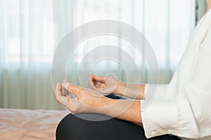 Covid-19 quarantine activity for senior woman meditating stay home to avoid risk