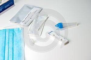 COVID19 selftest kits with medical mask isolated on white background. Sars Cov 2 antigen rapid test kit. Test kits for covid-19 ra
