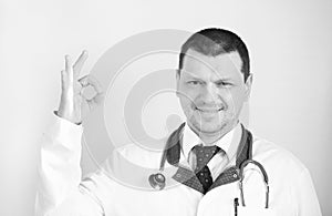 COVID-19 with smiling caucasian positive doctor with hope.Doctor makes a sign that everything is fine.Sign ok. Inspiring confidenc