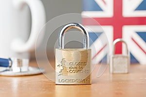 Covid-19 UK lockdown concept. A lock with the message photo