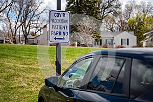 COVID vaccination site with sign and empty parking