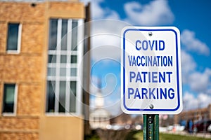 COVID vaccination site with sign and empty parking