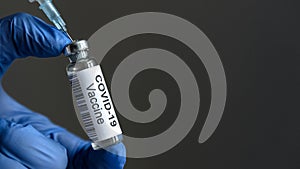 COVID-19 vaccine bottle and syringe for coronavirus cure in doctorÃ¢â¬â¢s hand for background photo