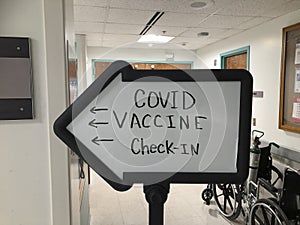 COVID-19 Vaccine check in at a hospital. As companies roll out more vaccine doses, more will be available for the general public photo