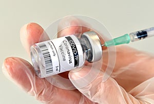 COVID-19 vaccine vial, bottle in hand at Pfizer laboratory photo