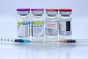 Covid-19 vaccine on a vial bottle and injections photo