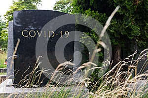 COVID-19 written on tombstone photo