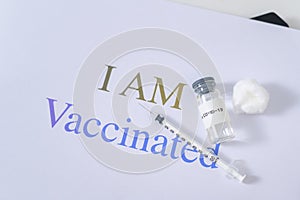 Covid19 coronavirus vaccine bottles and syringe injection tools for covid-19 immunization with text background , I am vaccinated