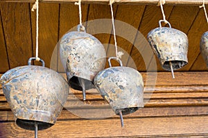 Cow-bells hanging on a wooden beam