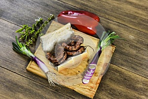 Cow bowels presented on a wooden board with ingredients,
