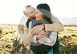 Cow farm, love and couple kiss in the countryside relax on a sustainability farm with cows. Interracial happy couple